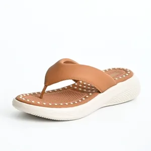 Detail view of women's brown platform flip flops featuring a comfortable massage footbed