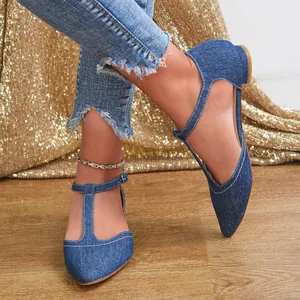 Close-up of elegant denim T-strap pointed-toe flat shoes for casual and office wear