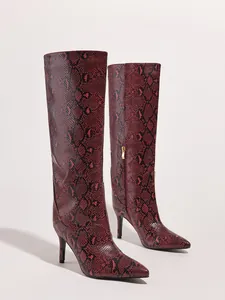 Stunning red snake-print knee-high boots with sharp pointed toe and stiletto heels