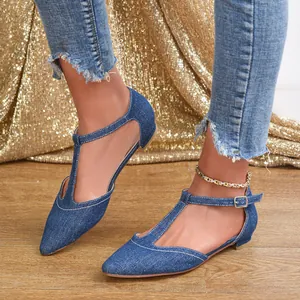 Side view of elegant blue denim T-strap flats with pointed toe and buckle detail