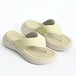 Close-up detail of women's platform flip-flops with massage footbed and thick sole