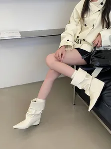 Elegant cream-colored slouchy wedge-heel mid-calf boots for women featuring a sharp pointed toe