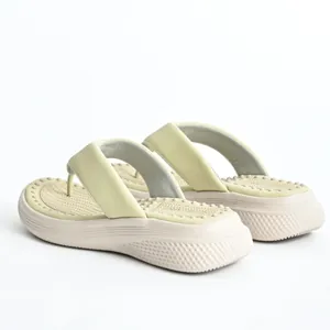 Close-up of women's platform flip-flops with comfortable massage footbed texture