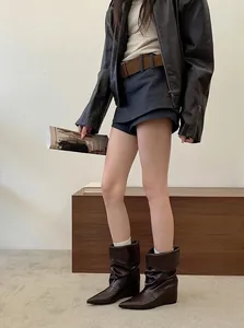 Chic slouchy brown mid-calf wedge boots with a pointed toe and stylish folded design for women.