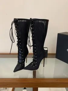Detailed view of black lace mesh high-heeled boots with elegant front lace-up design