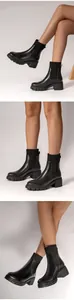 Detail views of black chunky heel Chelsea boots with knit sock cuff and lug sole