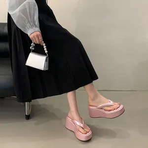Close-up of pink platform flip-flops with thick wedge soles for summer fashion