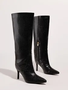 Detailed view of elegant black snakeskin stiletto boots with pointed toe and side zipper.