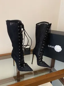 Elegant black lace-up mesh stiletto boots with pointed toe and front lacing detail.