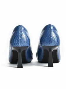 Rear view detail of blue crocodile textured pumps with elegant black wine glass heels