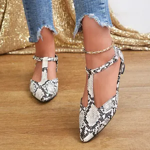 Detailed view of elegant women's flat shoes featuring snakeskin pattern and stylish T-strap