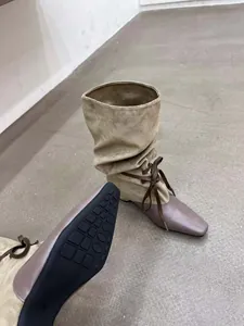 Vue détaillée du bout pointu et de la semelle antidérapante des bottes patchwork.