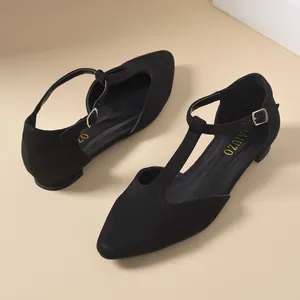 Side angle view of elegant black T-strap pointed flats showing buckle and suede texture