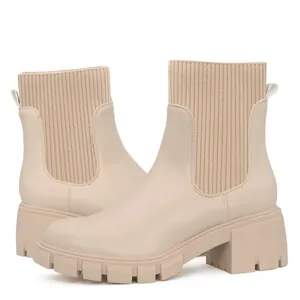 Beige knitted Chelsea boots with chunky lug sole and platform heel for women.