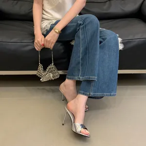 Metallic silver stiletto mules with an open-toe and elegant thin high heel design