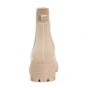 Back view of women's beige Chelsea boots featuring thick platform lug sole and knit details