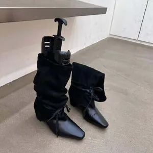 Bottes plissées noires vintage à bout pointu avec lacets, style cavalier western.