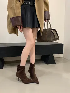 Chic dark brown suede pointed-toe ankle boots with slim stiletto heels and back zipper.