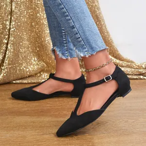 Elegant black suede T-strap pointed-toe flats for women styled with denim jeans