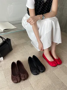 Elegant split-toe tabi ballet flats with dainty bows shown in red black and brown