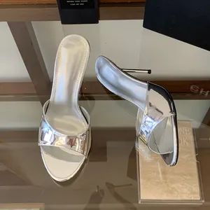 Chic silver metallic high-heeled mule sandals featuring a sleek minimalist one-strap design.