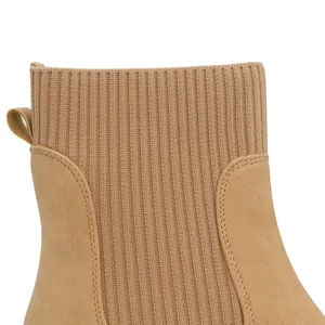 Detailed macro view showing the tan ribbed knit and suede texture of a Chelsea boot