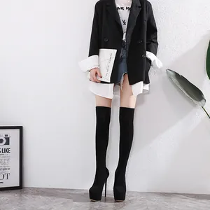 Full length view of model wearing black 16cm stiletto platform over-the-knee boots