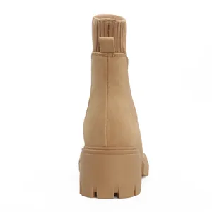 Detailed rear view of tan Chelsea boots with knitted collar and thick platform sole.