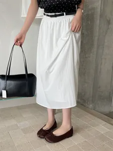 Close-up detail of brown tabi split-toe ballet flats with thin bow on model's feet