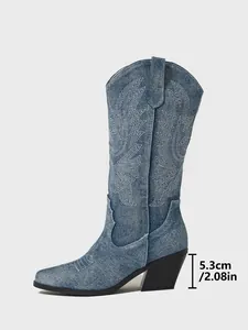 Detailed view of the 5.3cm chunky heel on these embroidered denim cowboy boots.