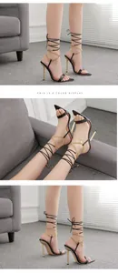 Dreifache Ansicht schwarzer Stiletto-Sandalen mit Goldkette und Schnürung am Modell.