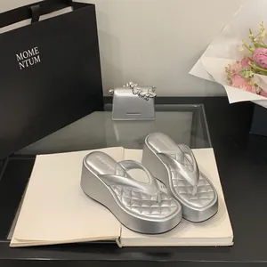Chic silver platform wedge flip-flops with a quilted strap and stylish high sole design