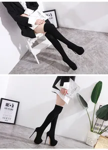 Side view of elegant black over-the-knee stiletto boots with 16cm platform heels
