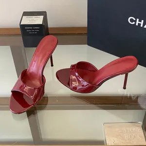 Close-up of glossy red stiletto mule with elegant open-toe design and slim high heel