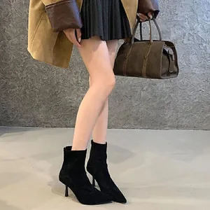 Chic black pointed-toe stiletto ankle boots featuring back zipper and slim high heels