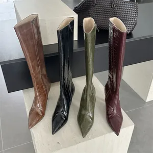Detailed view of crocodile embossed knee-high boots in four colors with pointed toes.