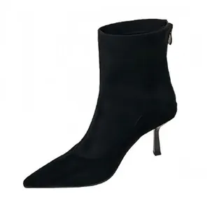 Elegant black pointed-toe stiletto ankle boots featuring back zipper and minimalist design