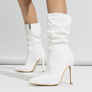 Elegant white patent leather slouched mid-calf boots featuring a pointed toe and stiletto heel
