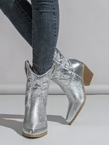 Stylish silver metallic Western cowboy boots featuring embroidery and chunky wooden heels
