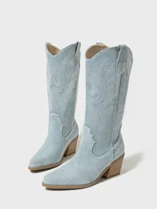 Light blue embroidered denim western boots with chunky heel and pointed toe design