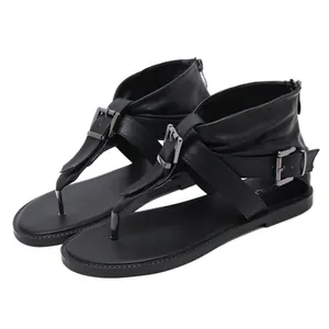 Stylish black flat gladiator sandals with thong toe and multiple ankle buckle straps.