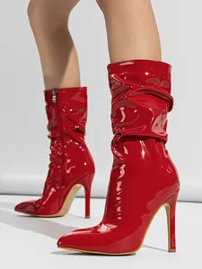 Vibrant red patent leather slouchy mid-calf boots with stiletto heel and pointed toe