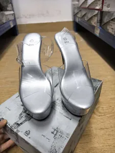 Detailed view of metallic silver 15cm platform sandals with transparent PVC straps and stiletto heel