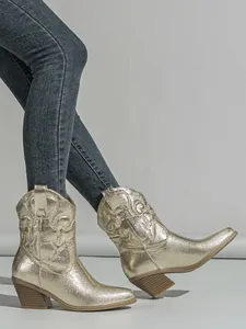 Detail view of metallic gold western cowboy boots with embroidery and chunky heels