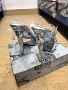 Close-up of 15cm stiletto high heels with silver finish and transparent platform