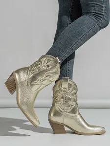 Detailed view of metallic gold western cowgirl boots with embroidery and block heel