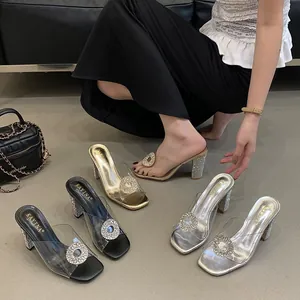 Glamorous transparent PVC chunky heel mules featuring elegant rhinestone buckle details