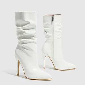Professional detailed view of white glossy slouchy mid-calf boots with stiletto high heels