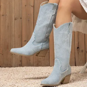 Vintage light blue denim western cowboy boots with pointed toe and block heel.