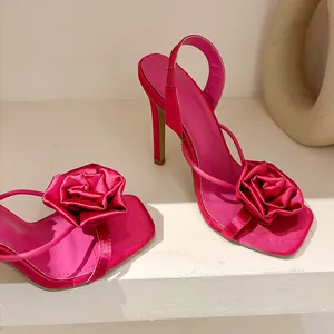 Elegant fuchsia silk high heel sandals featuring large rose detail and square toe design